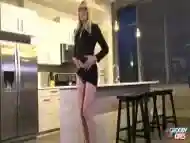 Lavish blonde shemale performs a seductive striptease in the kitchen