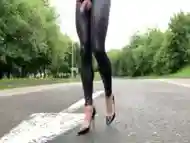 Road walking in PVC black leggings .