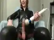 Shemale in latex outfit uses a vibrator on her cock