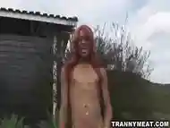 Tranny with dark skin and red hair jerks that cock