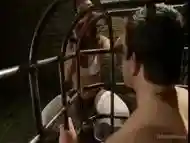 Enthralling brunette gets out of the cage to fuck her man