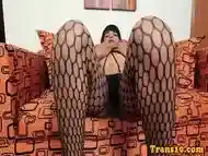 Latina tgirl posing her booty in fishnet lingerie